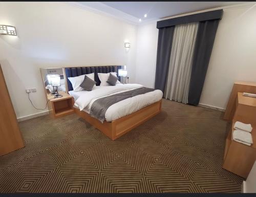 a hotel room with a bed and two night stands at فندق منازل قباء الفندقية in Al Madinah