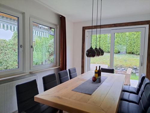 a dining room with a wooden table and chairs at Chalet Sabrina mit Außenpool im Sommer in Kaprun