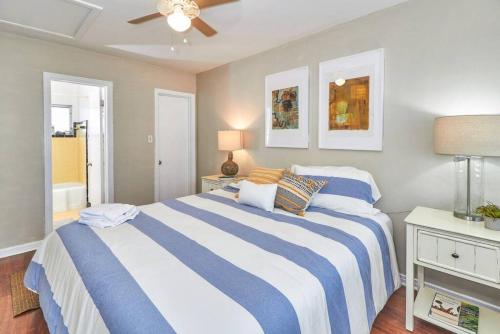 a bedroom with a blue and white bed with a ceiling fan at Vinoy Beach getaway Fun in the Sun Close to bars in St. Petersburg