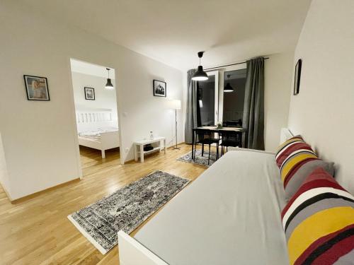 a living room with a white couch and a table at MUZETA11 - Modern Town Apartment with Balcony in Vienna