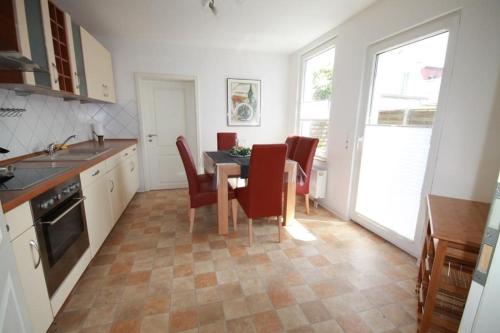 a kitchen with a table and chairs in a kitchen at Lüttje Gesine Lüttje Gesine in Norderney