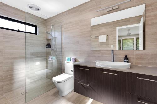 a bathroom with a sink and a toilet and a shower at Forest Haven 2 BR Styled Modern Sanctuary at Maleny in Maleny