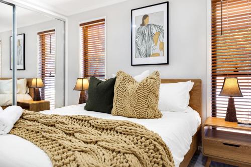 a bedroom with a bed with a blanket on it at Forest Haven 2 BR Styled Modern Sanctuary at Maleny in Maleny