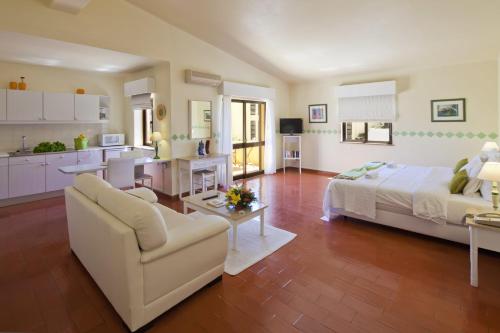 a large living room with a bed and a kitchen at Villa Mar Azul in Lagos