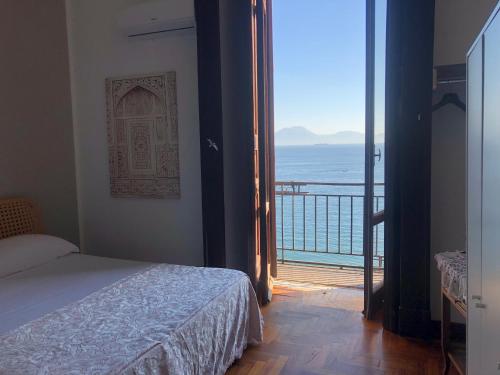 a bedroom with a bed and a view of the ocean at B&B Vista Mare in Naples