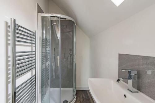 a bathroom with a shower and a white tub at Reed Loft in Kingston