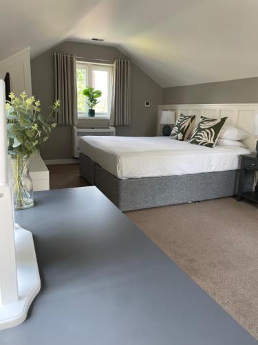 a bedroom with a large bed and a window at George Hotel, BW Signature Collection in Norwich
