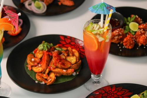 a table with plates of food and a drink at Crowne Plaza Pune City Centre by IHG in Pune