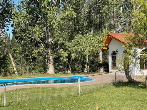 a swimming pool in a yard next to a house at WINEHOUSE in Chacras de Coria