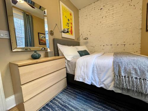 a bedroom with a bed and a mirror at 2F Chicago's Little Italy near West Loop & Downtown in Chicago