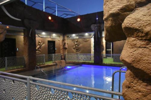 a large swimming pool with a rock wall at La Ru in Mount Moreland