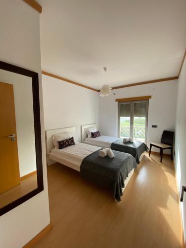 - une chambre avec 2 lits et un miroir dans l'établissement Apartamento Rua do Sol by Localhosting, à Albufeira