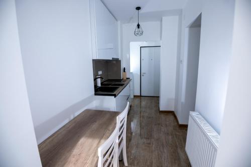 a kitchen with white walls and a counter top at Apartament CENTRAL in Târgu Jiu
