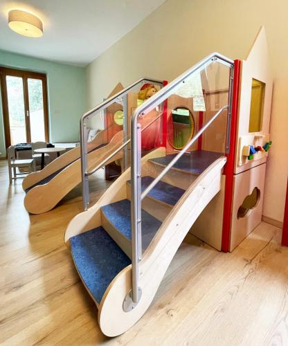 two bunk beds in a room with a slide at Hotel Residence MaVie in Lagundo