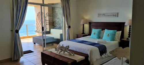 a bedroom with a bed with a view of the ocean at Santorini 402B in Margate