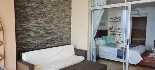 a living room with a couch and a bedroom at Santorini H in Margate