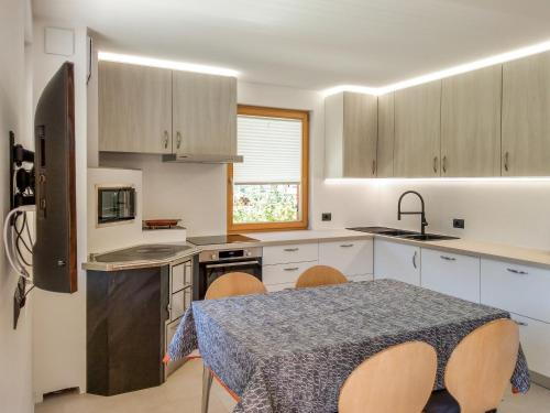 uma cozinha com uma mesa e cadeiras numa cozinha em Paragole em Pera