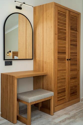 a dressing room with a mirror and a wooden cabinet at Ansira Fethiye in Fethiye