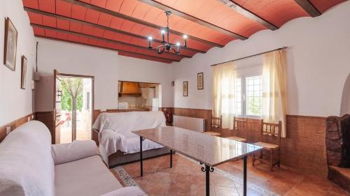 a living room with a table and a couch at Molino de Peralta Pozo Alcón by Ruralidays in Pozo Alcón