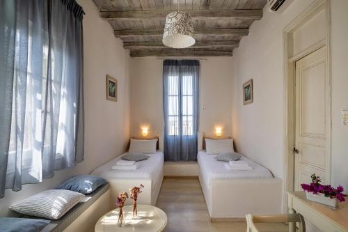 a room with two beds and a window at Olia Hotel in Tourlos