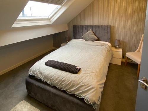 a bedroom with a large bed with a window at New York Apartment in Heeley