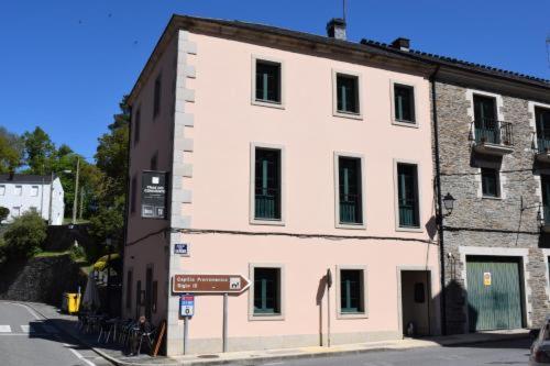 a large white building on the side of a street at Tras do convento in Samos
