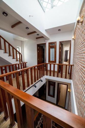 a room with wooden stairs and a brick wall at The Land Hotel & Apartment in Vung Tau