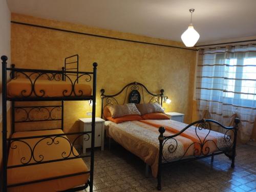 a bedroom with a large bed and a bunk bed at Alloggio Agrituristico Abruzzomio - Casa Somarello in Goriano Valli
