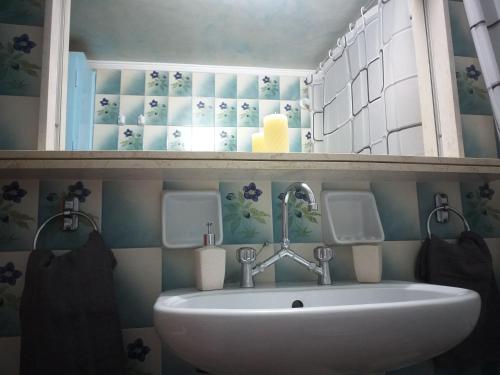 a bathroom with a white sink in a room at Oropos Memories House in Skála Oropoú
