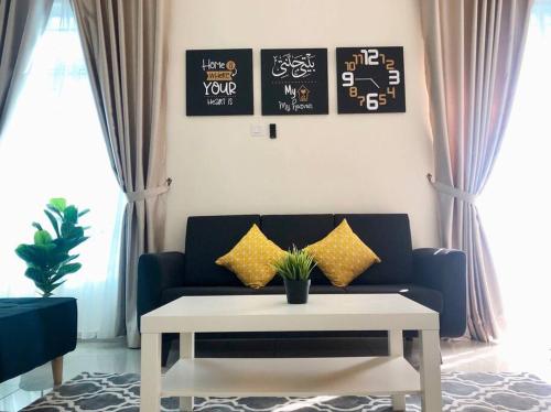 a living room with a couch and a coffee table at RumahKu Homestay, Taman Jasin Perdana in Jasin