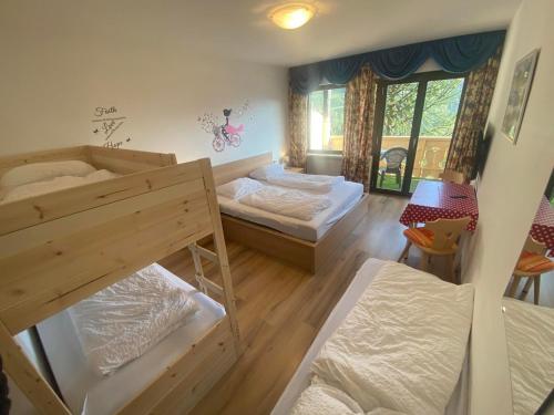 a room with two bunk beds and a table at Laimerhof in Rifiano