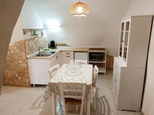 a kitchen with a table and a kitchen with a table and chairs at Alloggio Agrituristico Abruzzomio - Casa Somarello in Goriano Valli