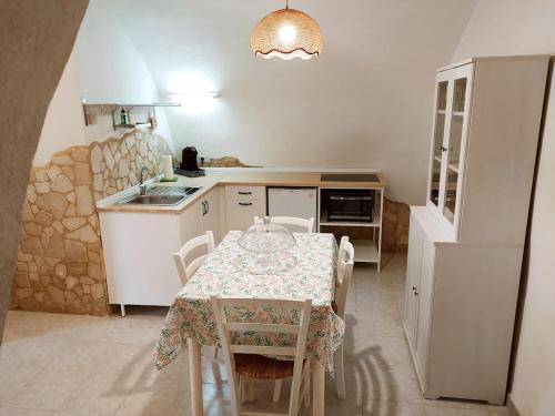 una cucina con tavolo e una cucina con tavolo e sedie di Alloggio Agrituristico Abruzzomio - Casa Somarello a Goriano Valli