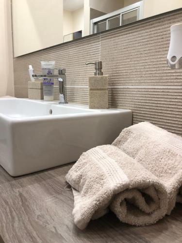 a bathroom with a white tub and a sink at Etna holiday in Zafferana Etnea