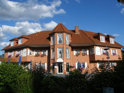 a large brick house with a brown roof at Hotel Flora in Herzlake