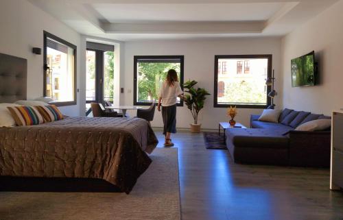 a woman is standing in a living room at Plasencia Plaza Mayor Luxury in Plasencia