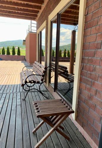 a couple of benches sitting on a deck at Four Seasons In Carpathians in Migovo