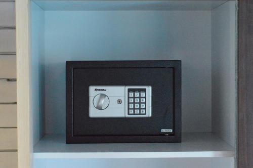 a microwave oven in a shelf in a cabinet at The MG Villa & SPA in Nusa Penida