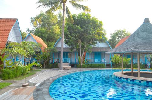 a swimming pool in front of a resort at The MG Villa & SPA in Nusa Penida