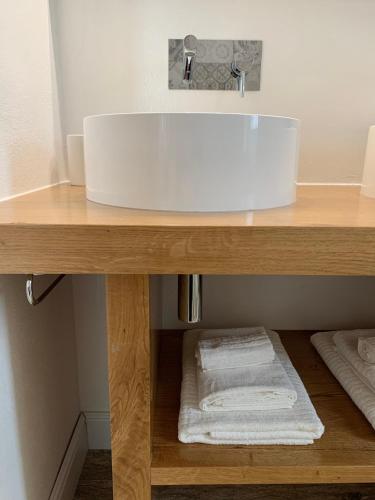 a bathroom counter with a sink and two folded towels at Casa Lorica Marilleva 1400 in Marilleva