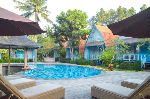 a swimming pool in front of a house at The MG Villa & SPA in Nusa Penida
