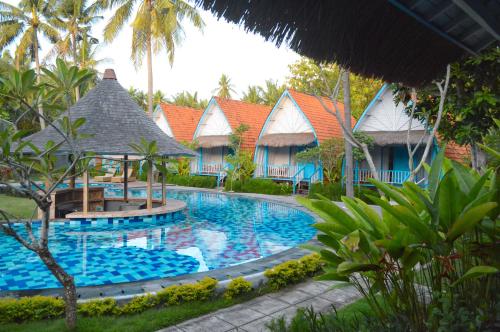 a swimming pool in front of a resort at The MG Villa & SPA in Nusa Penida