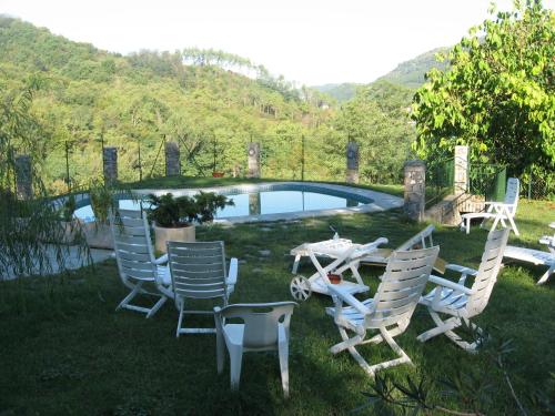a group of chairs and a table in front of a pool at B&B Ca dei Fre in Genova