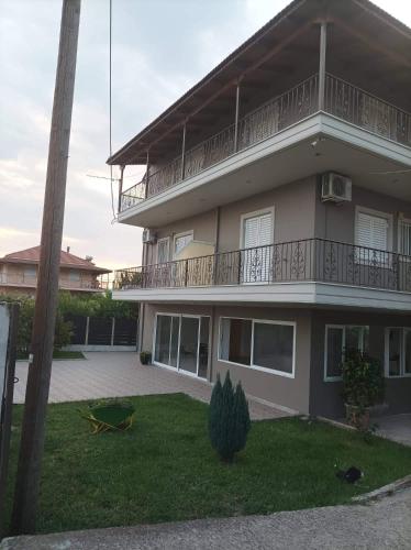 a apartment building with a balcony and a yard at Eirini's Apartment in Missolonghi