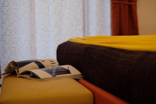 a book sitting on a couch next to a bed at LeNotti Verona in Verona