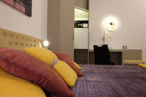 a bedroom with a bed with pillows on it at LeNotti Verona in Verona