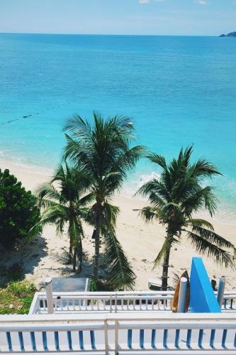 a view of a beach with palm trees and the ocean at AT SEA Patong in Patong Beach