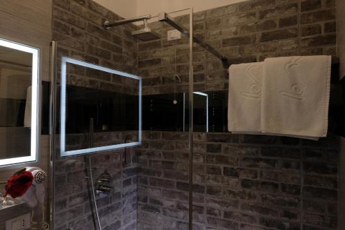 a bathroom with a glass shower stall with towels at LeNotti Verona in Verona