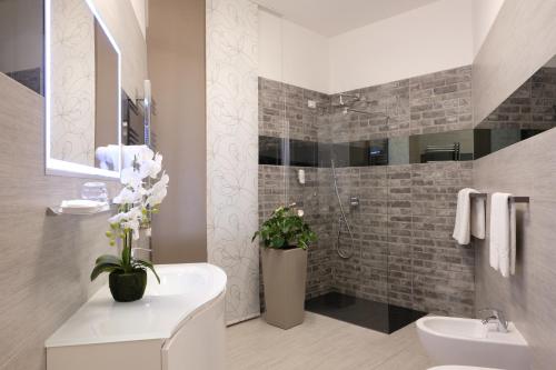 a bathroom with a sink and a toilet and a shower at LeNotti Verona in Verona
