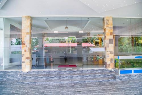 a store front with glass windows and a table at Hotel Remaco in Katunayake